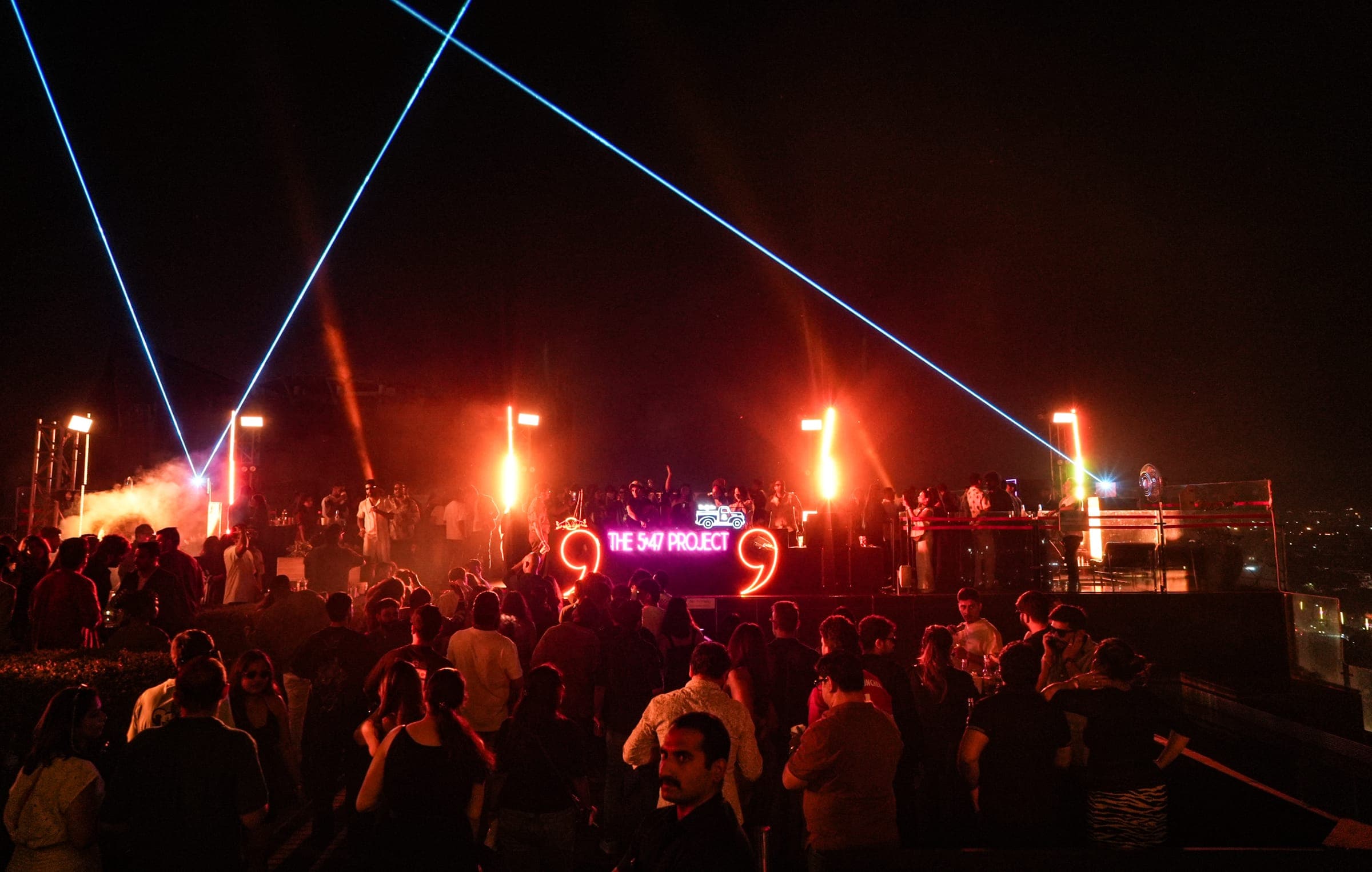 Crowd under lasers at an Akhlad Ahmed live set
